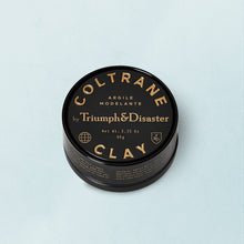 Load image into Gallery viewer, TRIUMPH AND DISASTER- COLTRANE CLAY HAIR PRODUCT
