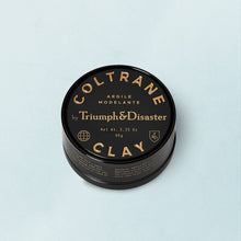 Load image into Gallery viewer, TRIUMPH AND DISASTER- COLTRANE CLAY HAIR PRODUCT
